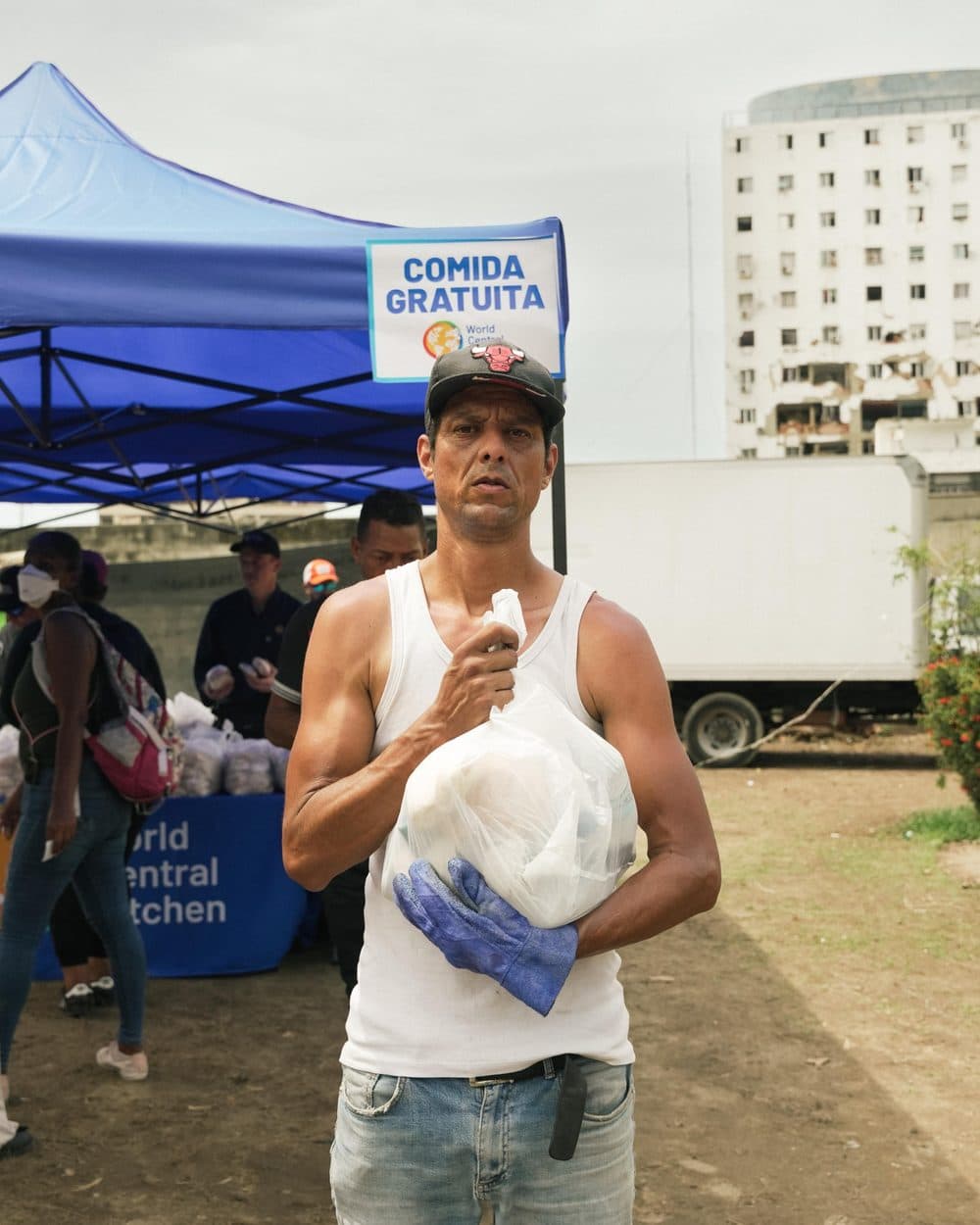 Hombre con una bolsa de comida gratuita de World Central Kitchen en La Guaira